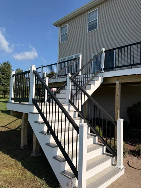 Composite deck stairs with black railings and white risers