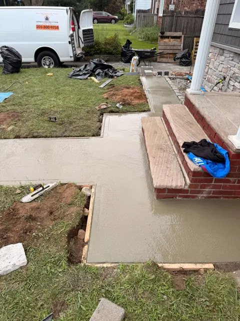 New concrete landing around brick entry steps