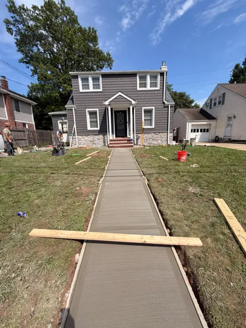Fresh concrete front walkway held in timber formwork