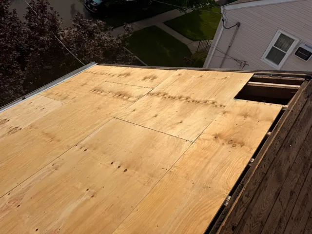 New plywood sheathing installed on a roof