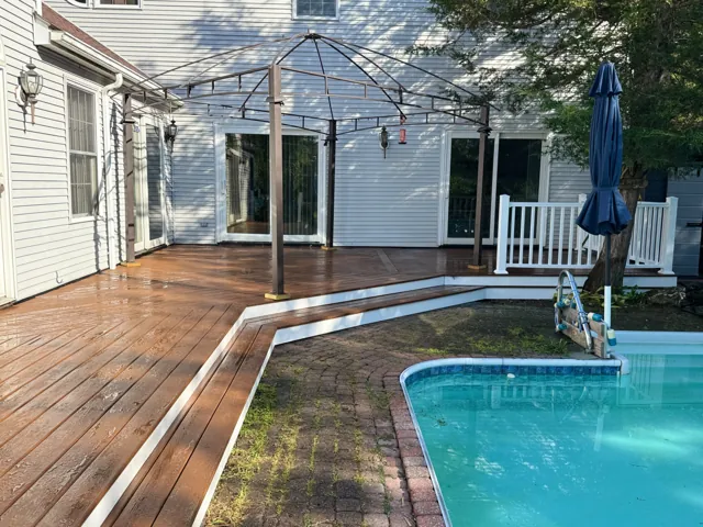 Finished poolside wood deck and outdoor living space