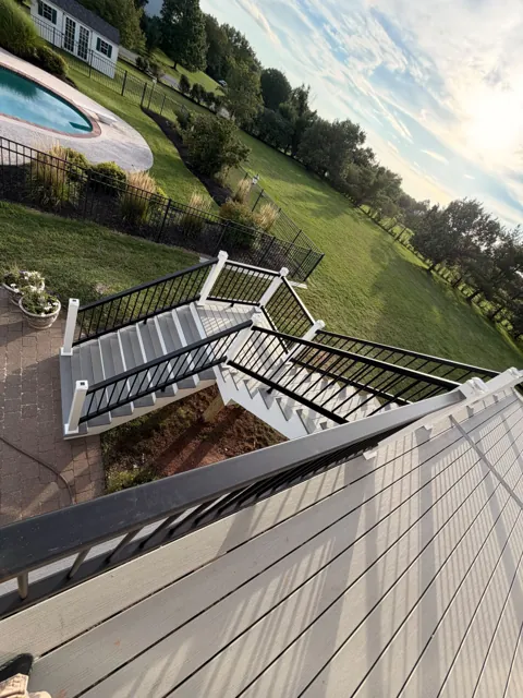 View from a raised deck toward a backyard pool