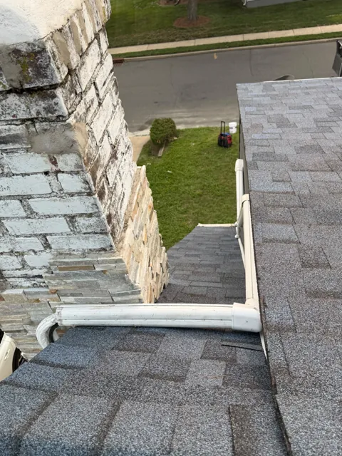 Flashing detail around a painted brick chimney