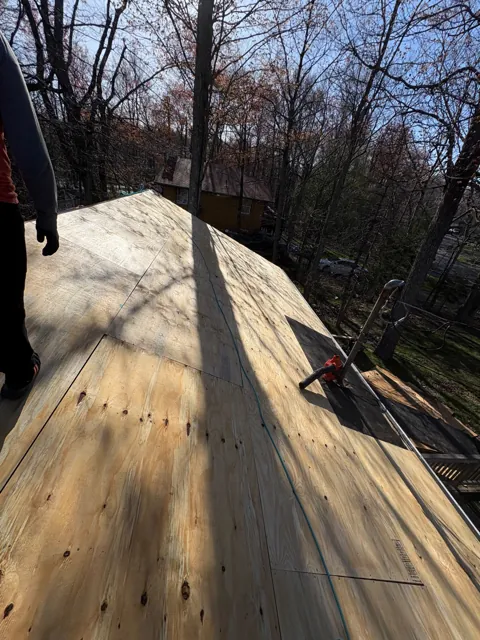 Plywood sheathing installed near a roof ridge